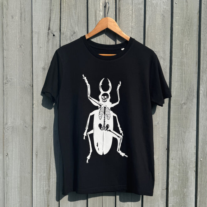 Metamorphosis_Skeleton Beetle_Kafka_T-Shirt - against wooden backdrop