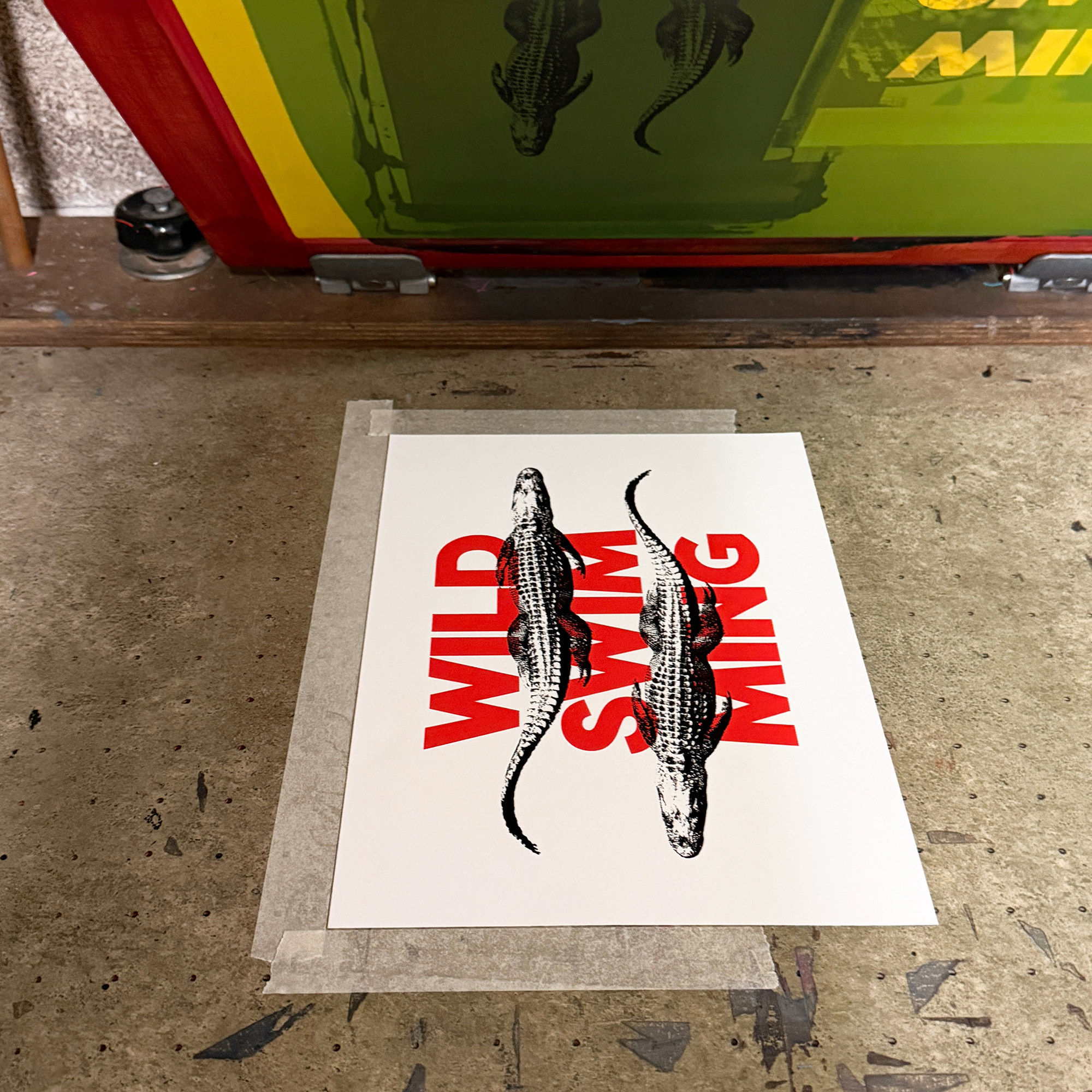 Screen Printed Poster - Wild Swimming_Small A4 Size - process shot showing second black layer of alligators on print bed.