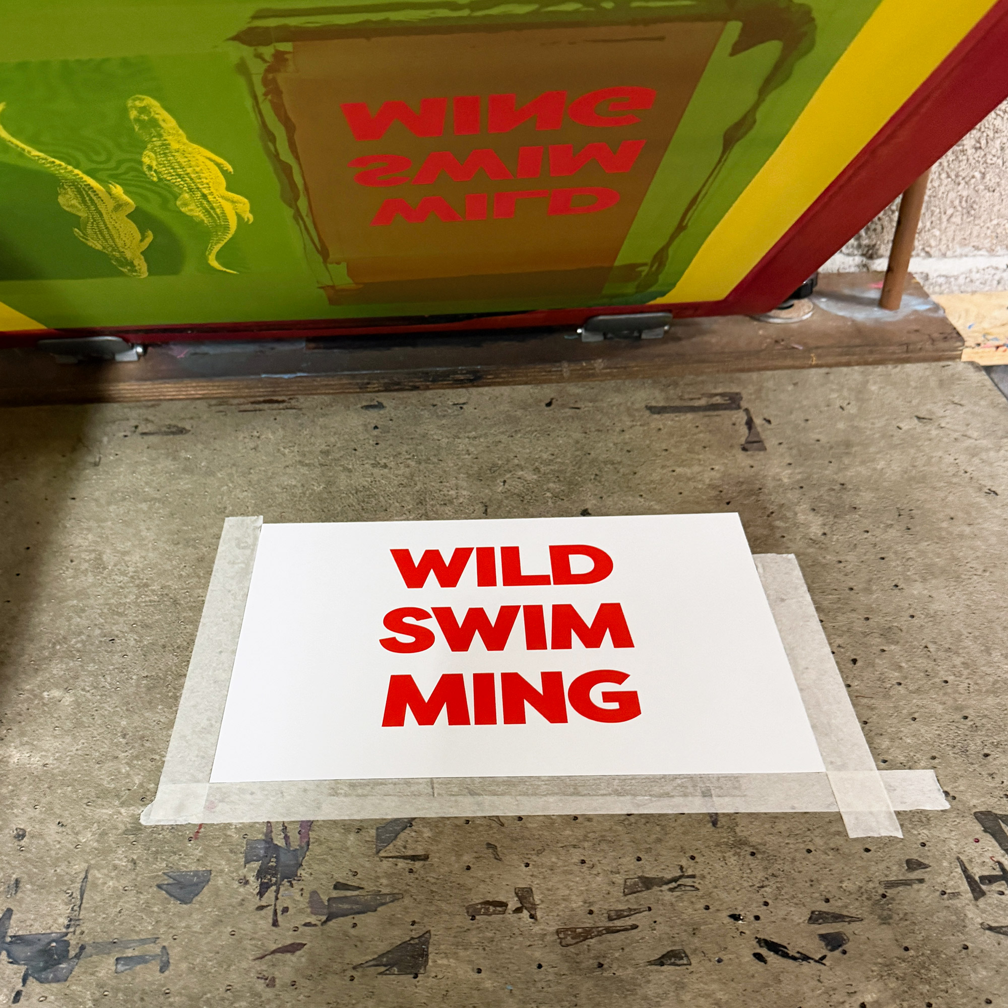 Screen Printed Poster - Wild Swimming_Small A4 Size - process shot showing red typography on print bed.